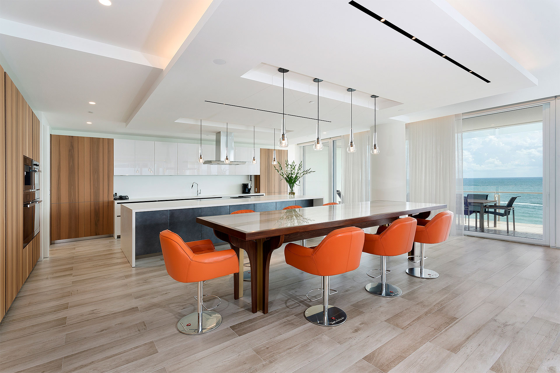 Luxury Open floor plan kitchen & dining room overlooking the ocean in Florida by Woolems Luxury Builders